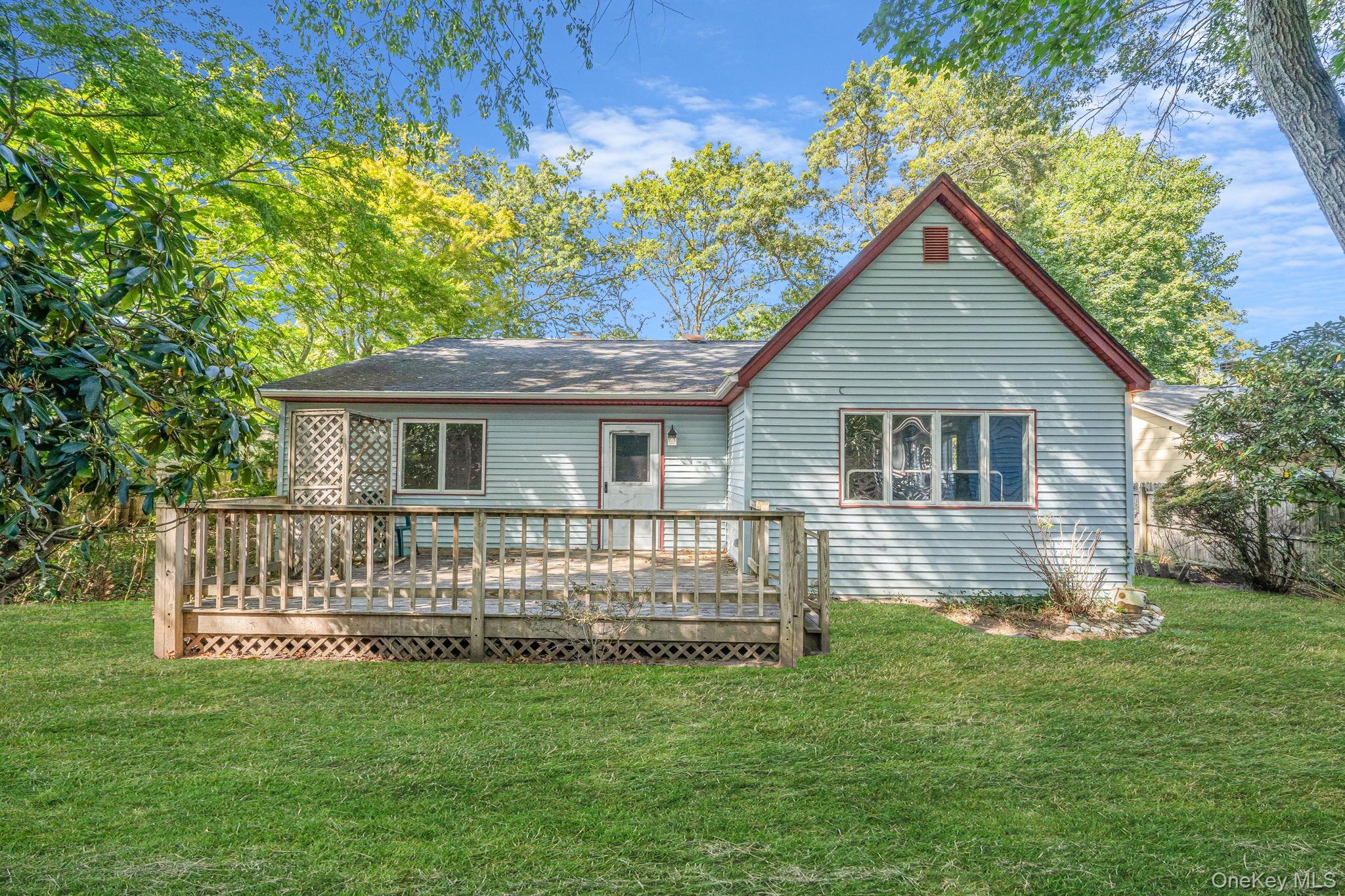 60 Hawthorne Road Rocky Point, NY 11778 - Photo 19 of 23 Back of house featuring a lawn and a wooden deck