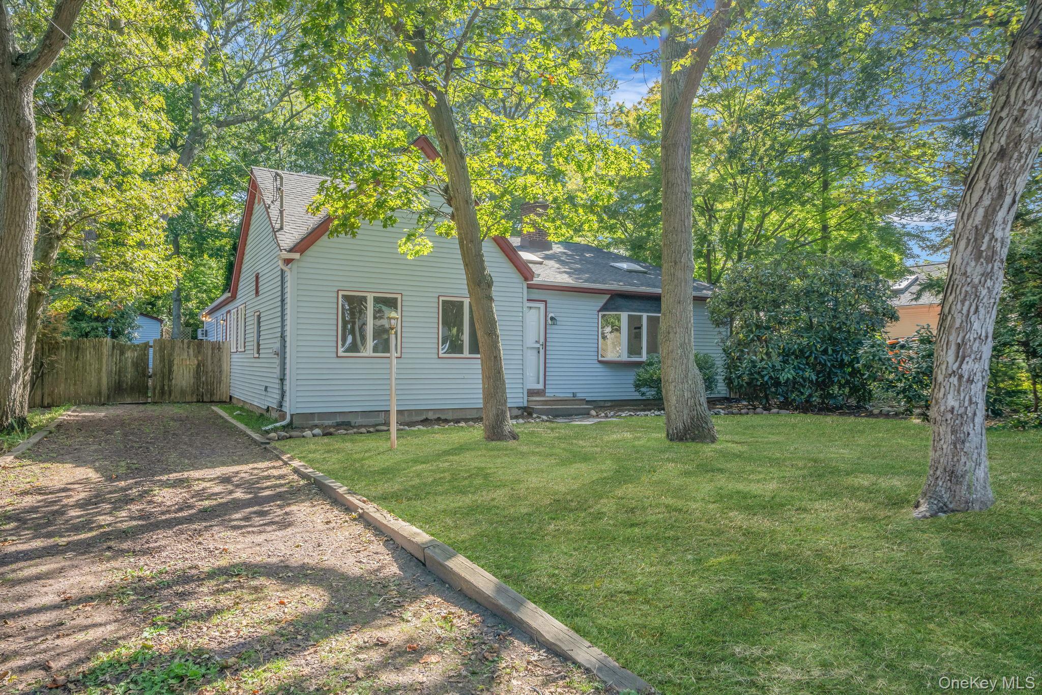 60 Hawthorne Road Rocky Point, NY 11778 - Photo 22 of 23 Rear view of property featuring roof with shingles