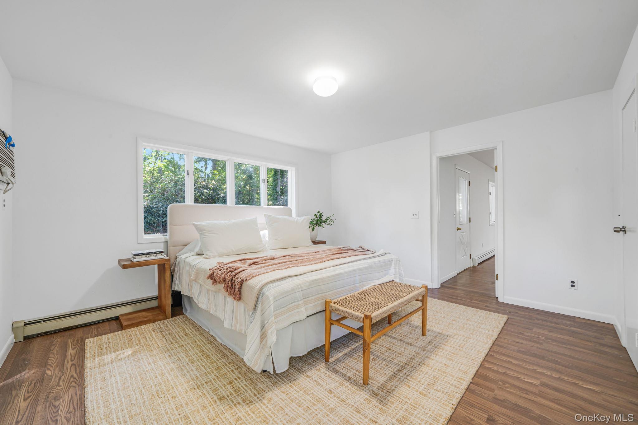 60 Hawthorne Road Rocky Point, NY 11778 - Photo 10 of 23 Bedroom featuring baseboard heating and dark wood-type flooring