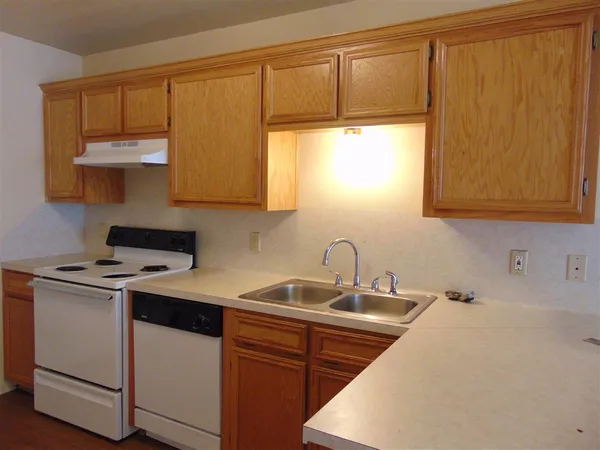 a kitchen with a sink cabinets and a window
