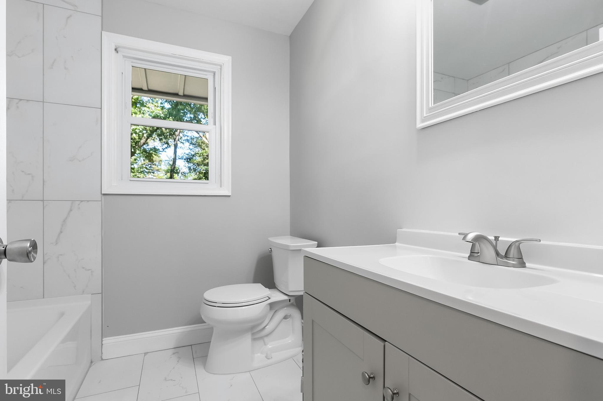 405 Hamilton Road Glassboro, NJ 08028 - Photo 15 of 28 a bathroom with a sink a toilet and shower