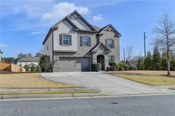 a front view of a house with a yard and garage