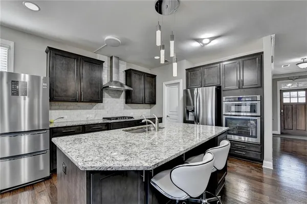 a large kitchen with stainless steel appliances kitchen island granite countertop a large counter top stainless steel appliances and cabinets