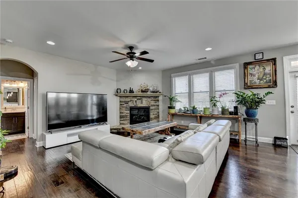 a living room with furniture a fireplace and a flat screen tv