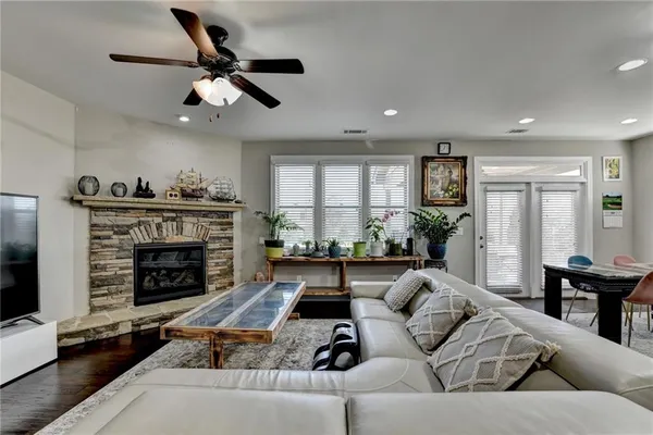 a living room with furniture and a view of kitchen