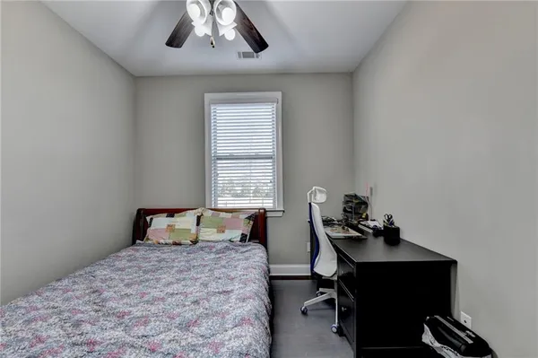 a bed room with a bed and a ceiling fan