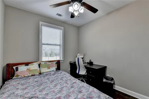 a bedroom with a bed and a ceiling fan