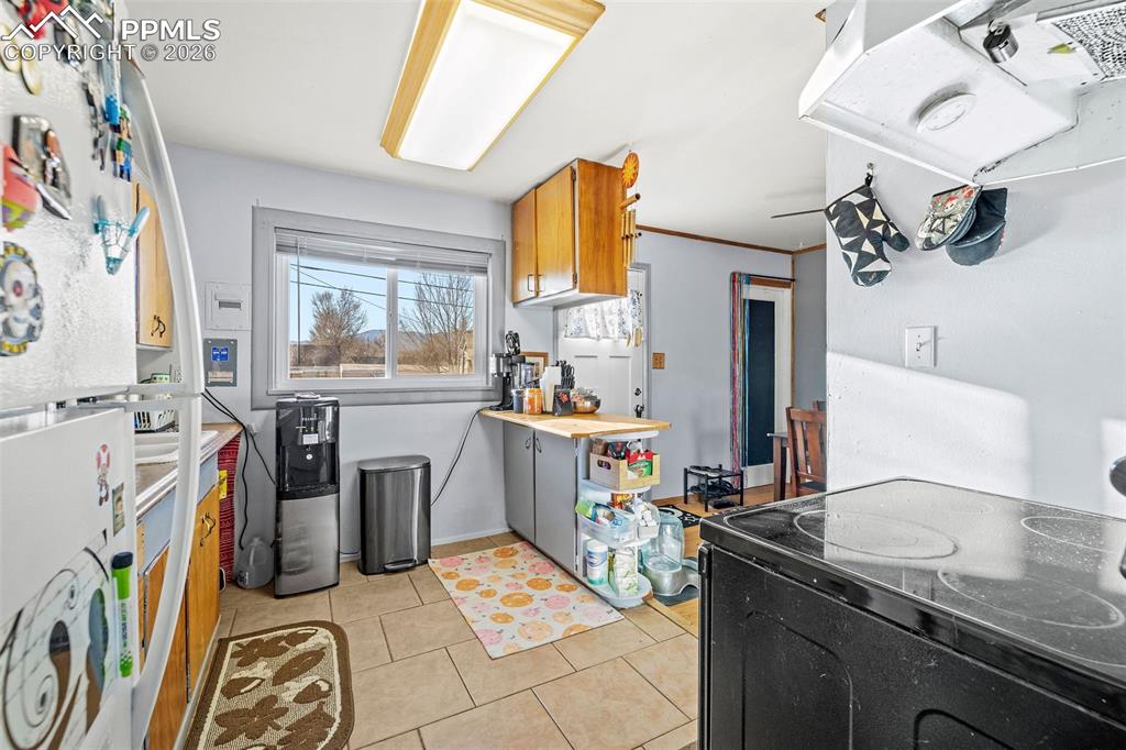 26 Easy Street Colorado Springs, CO 80911 - Photo 11 of 19 a view of a kitchen with fridge and workspace