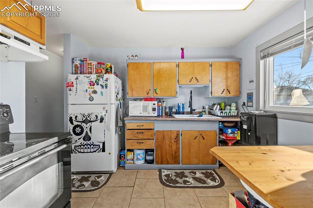 26 Easy Street Colorado Springs, CO 80911 - Photo 10 of 19 a kitchen with stainless steel appliances granite countertop a stove and a refrigerator