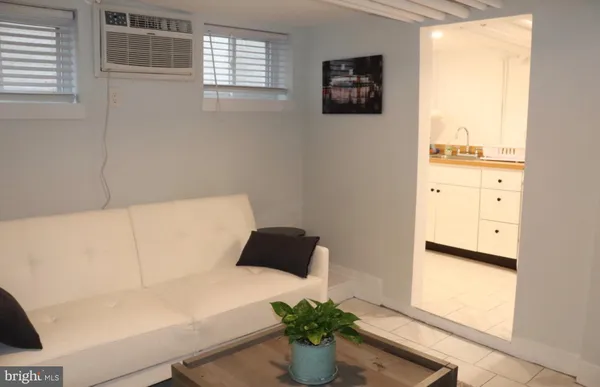 a living room with furniture and a potted plant