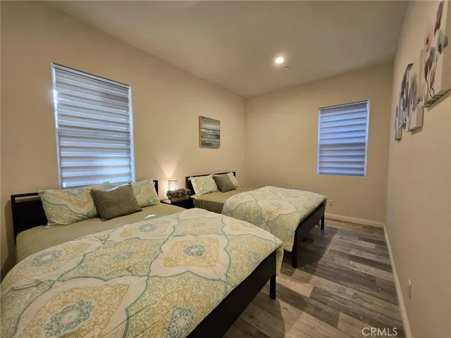 a bedroom with two beds and a window