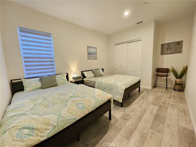 a large bedroom with two beds and painted walls