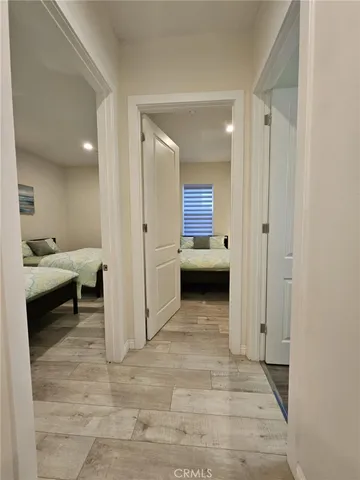 a view of a hallway view with couch and a bathroom with a sink