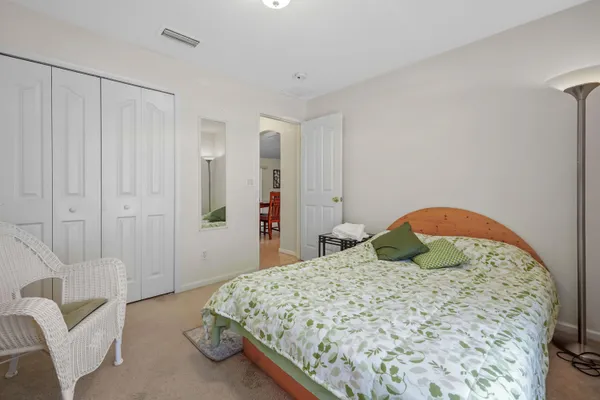 a bedroom with a bed and a chair