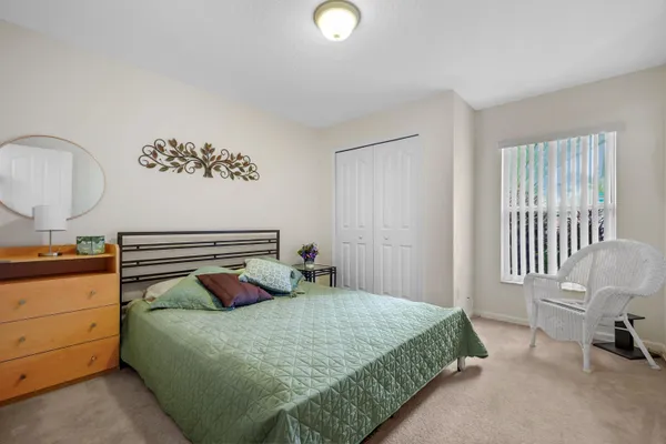 a bedroom with a bed and a chair