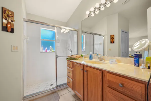 a bathroom with a granite countertop sink a toilet and a mirror