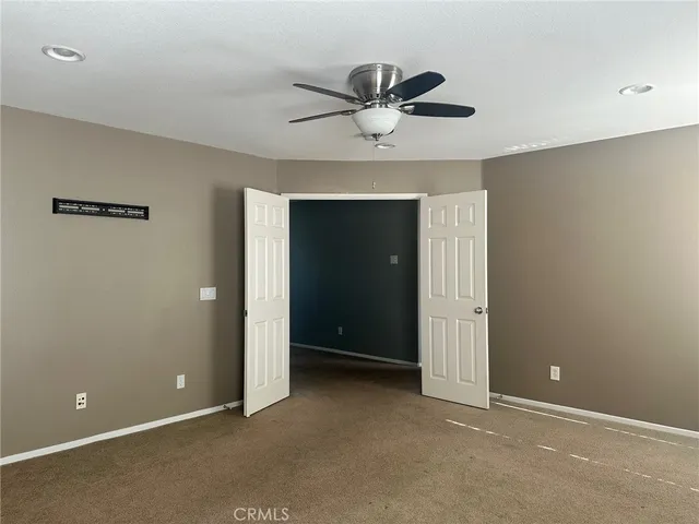 a view of an empty room with a ceiling fan