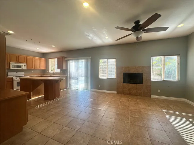 a view of kitchen with cabinets and window