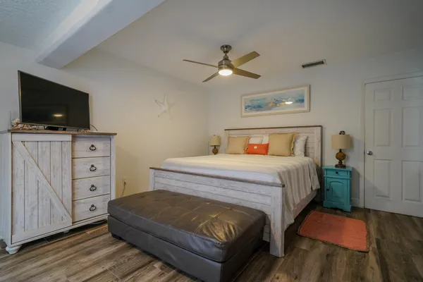 a bedroom with a bed and flat screen tv