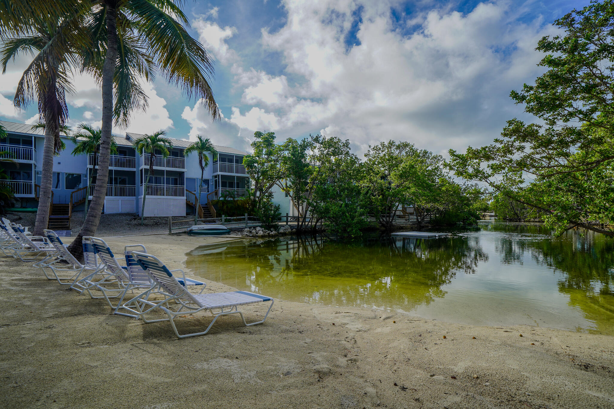 1500 Ocean Bay Drive, Unit H5 Key Largo, FL 33037 - Photo 14 of 24 a view of a swimming pool with a table and chairs