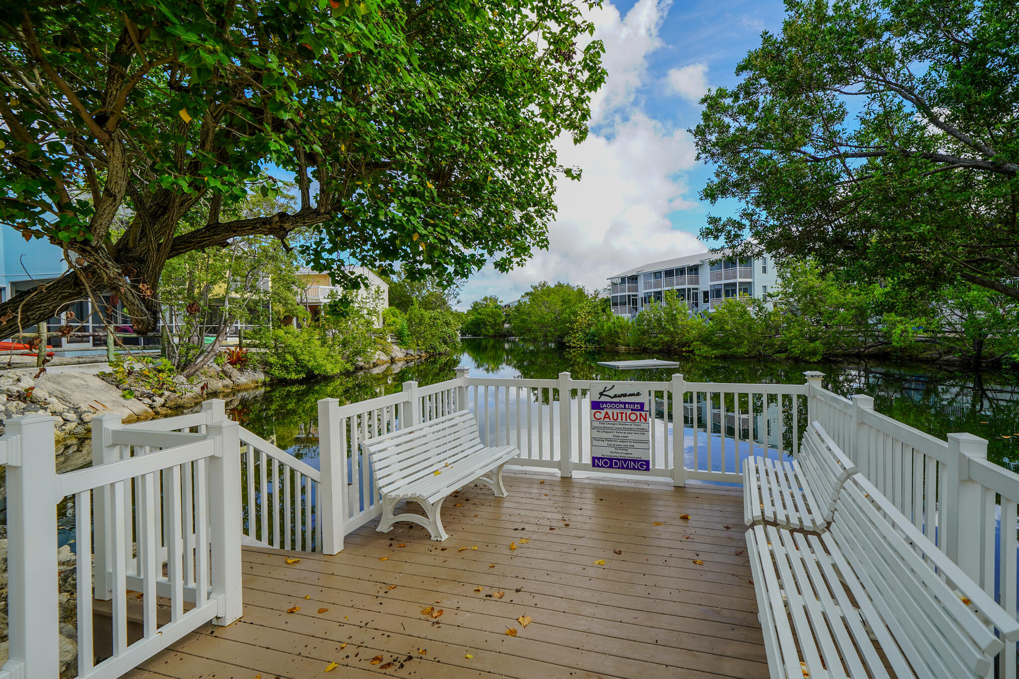 1500 Ocean Bay Drive, Unit H5 Key Largo, FL 33037 - Photo 16 of 24 a view of deck and patio with swimming pool and wooden fence