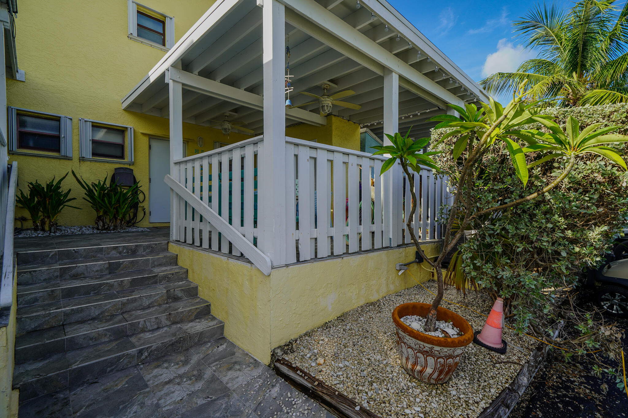1500 Ocean Bay Drive, Unit H5 Key Largo, FL 33037 - Photo 3 of 24 a backyard of a house with wooden floor barbeque oven and plants