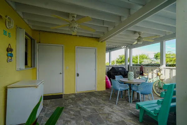 a view of a porch with chairs and backyard