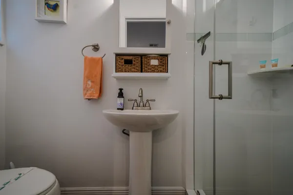 a bathroom with a sink toilet and mirror