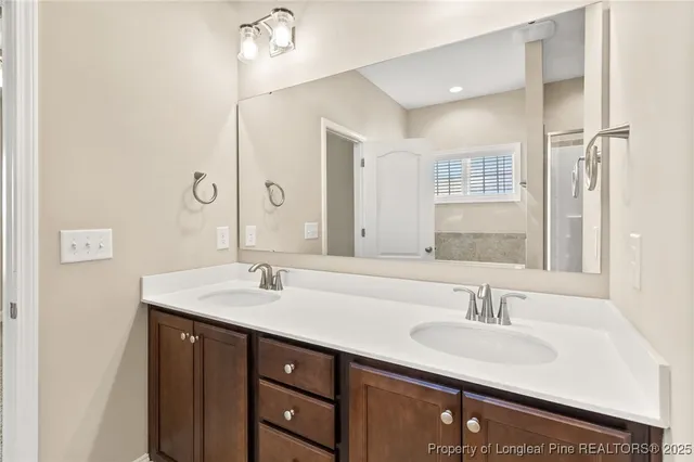a bathroom with a sink double vanity and a mirror