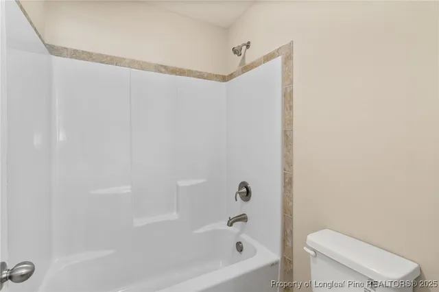 a bathroom with a toilet and a bathtub