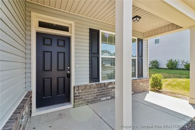 a view of a door of the house and a yard