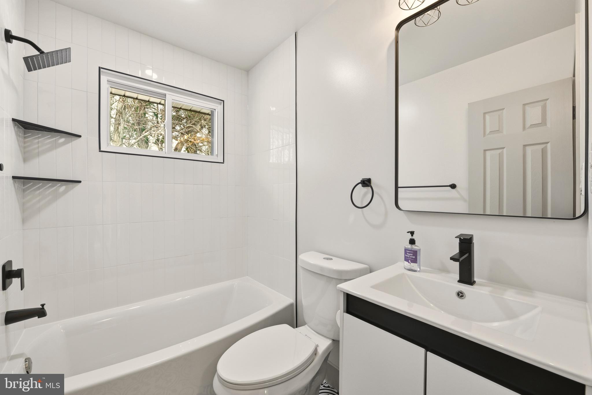 5717 Colon Terrace Temple Hills, MD 20748 - Photo 14 of 32 a bathroom with a sink a toilet and shower
