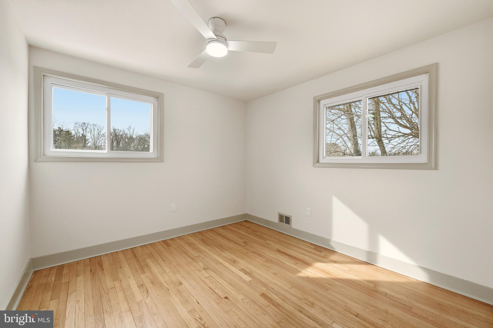 5717 Colon Terrace Temple Hills, MD 20748 - Photo 15 of 32 a view of empty room with wooden floor and fan