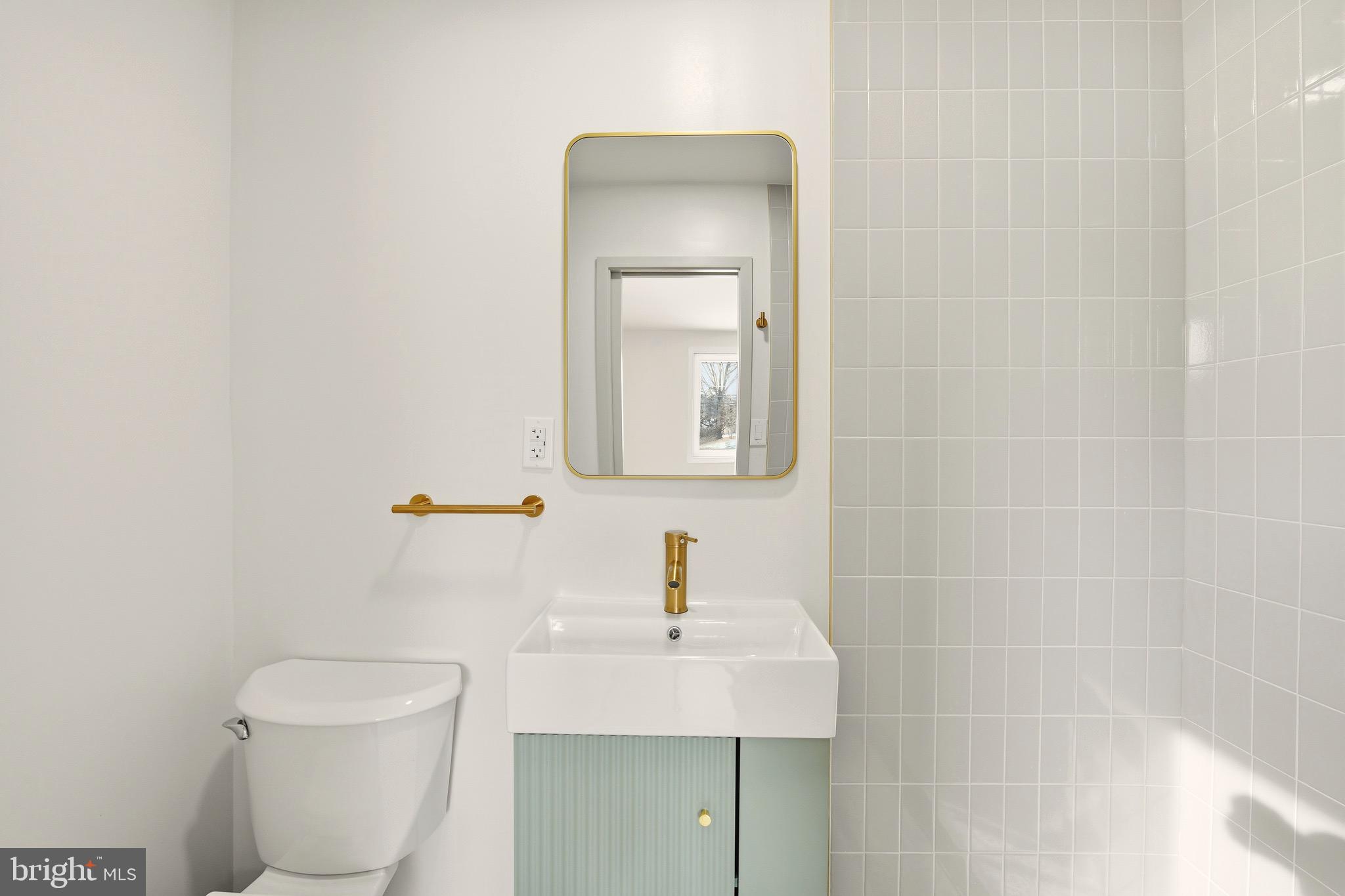 5717 Colon Terrace Temple Hills, MD 20748 - Photo 19 of 32 a bathroom with a toilet a sink and mirror