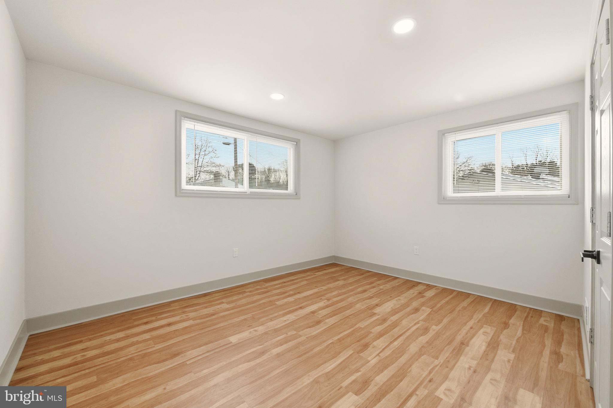 5717 Colon Terrace Temple Hills, MD 20748 - Photo 21 of 32 a view of an empty room with wooden floor and a window