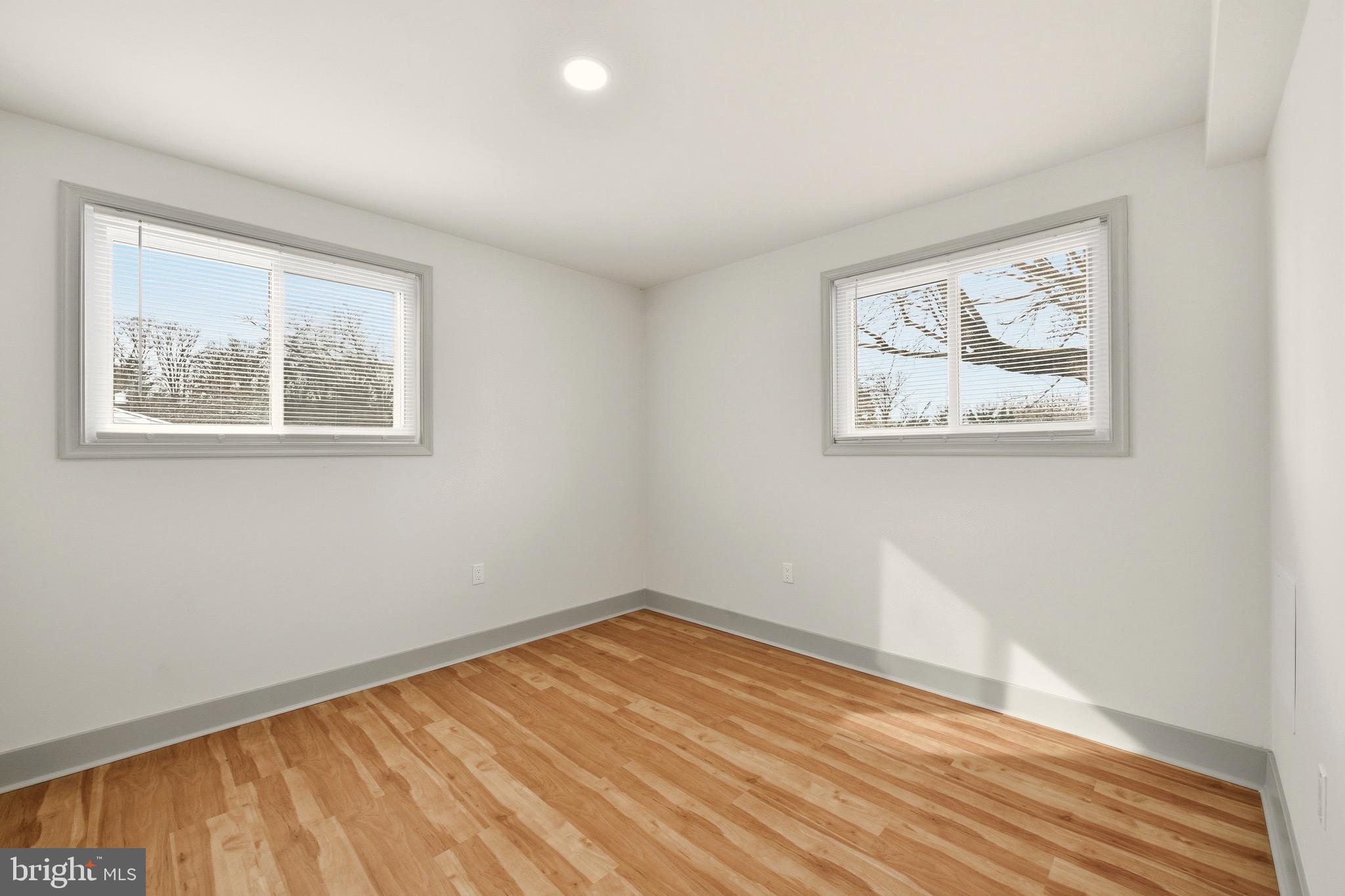 5717 Colon Terrace Temple Hills, MD 20748 - Photo 23 of 32 a view of an empty room with wooden floor and a window