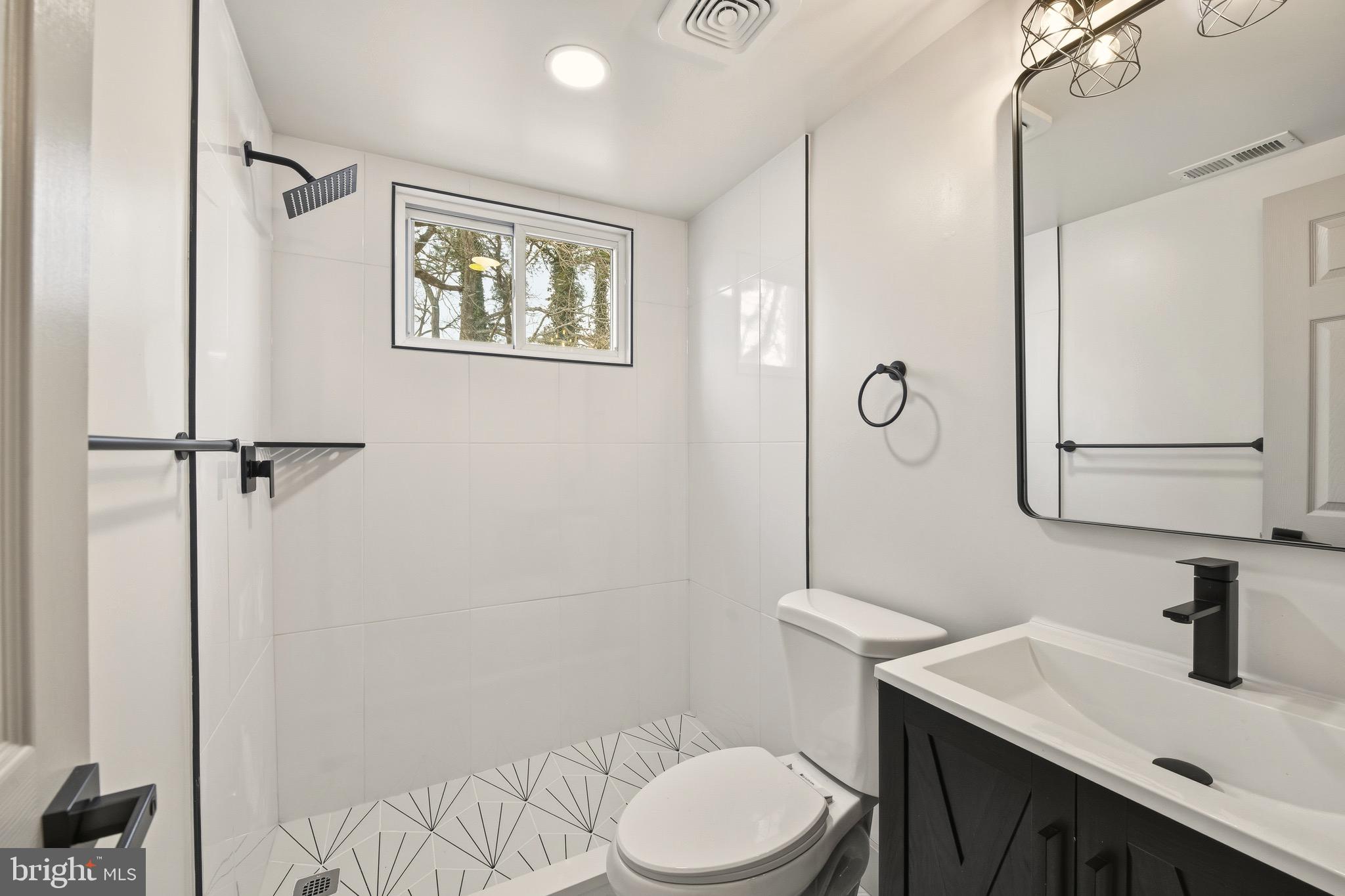 5717 Colon Terrace Temple Hills, MD 20748 - Photo 27 of 32 a bathroom with a sink vanity mirror and toilet