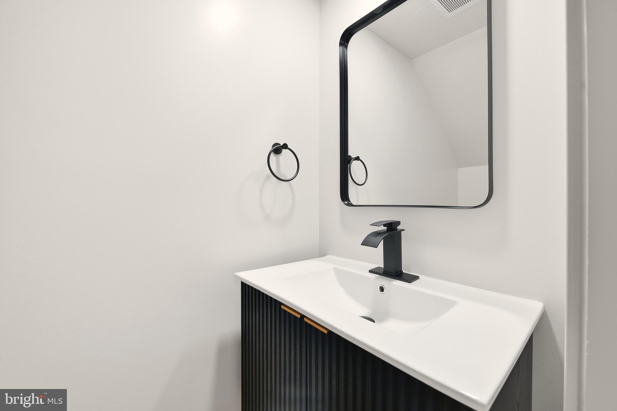 5717 Colon Terrace Temple Hills, MD 20748 - Photo 28 of 32 a bathroom with a sink and mirror