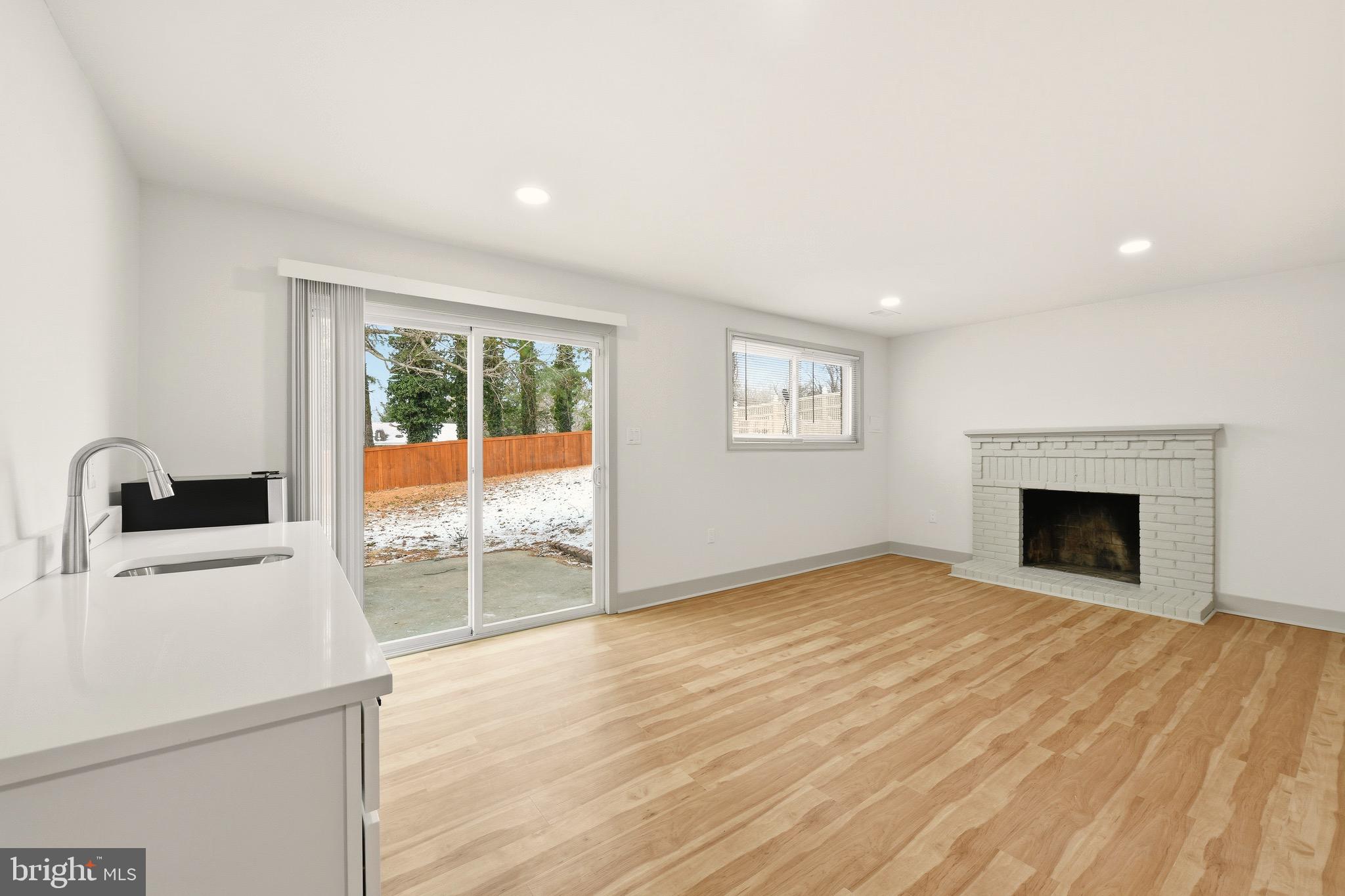 5717 Colon Terrace Temple Hills, MD 20748 - Photo 29 of 32 a view of empty room with wooden floor and fireplace