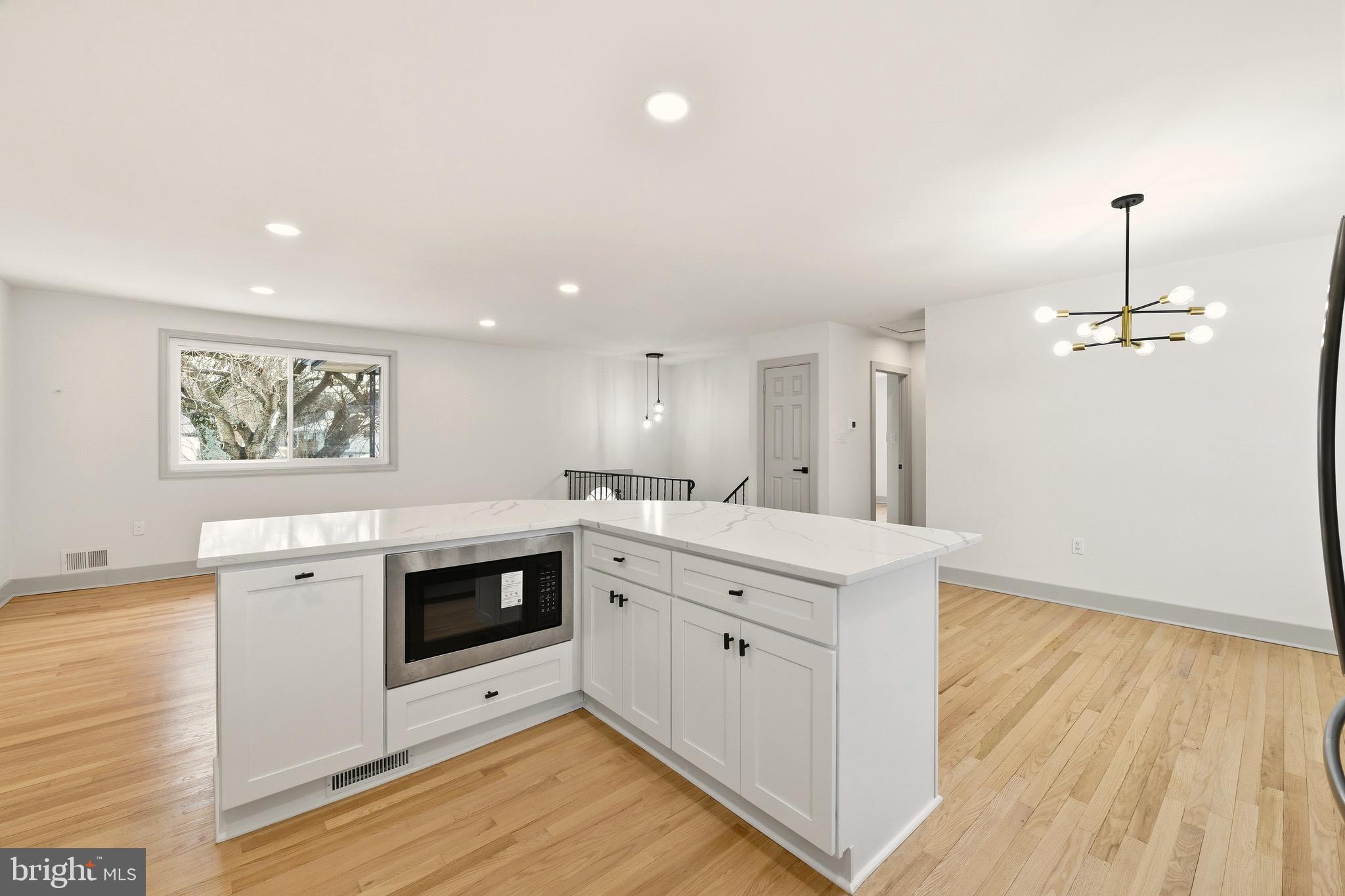 5717 Colon Terrace Temple Hills, MD 20748 - Photo 6 of 32 a kitchen with a sink cabinets and wooden floor