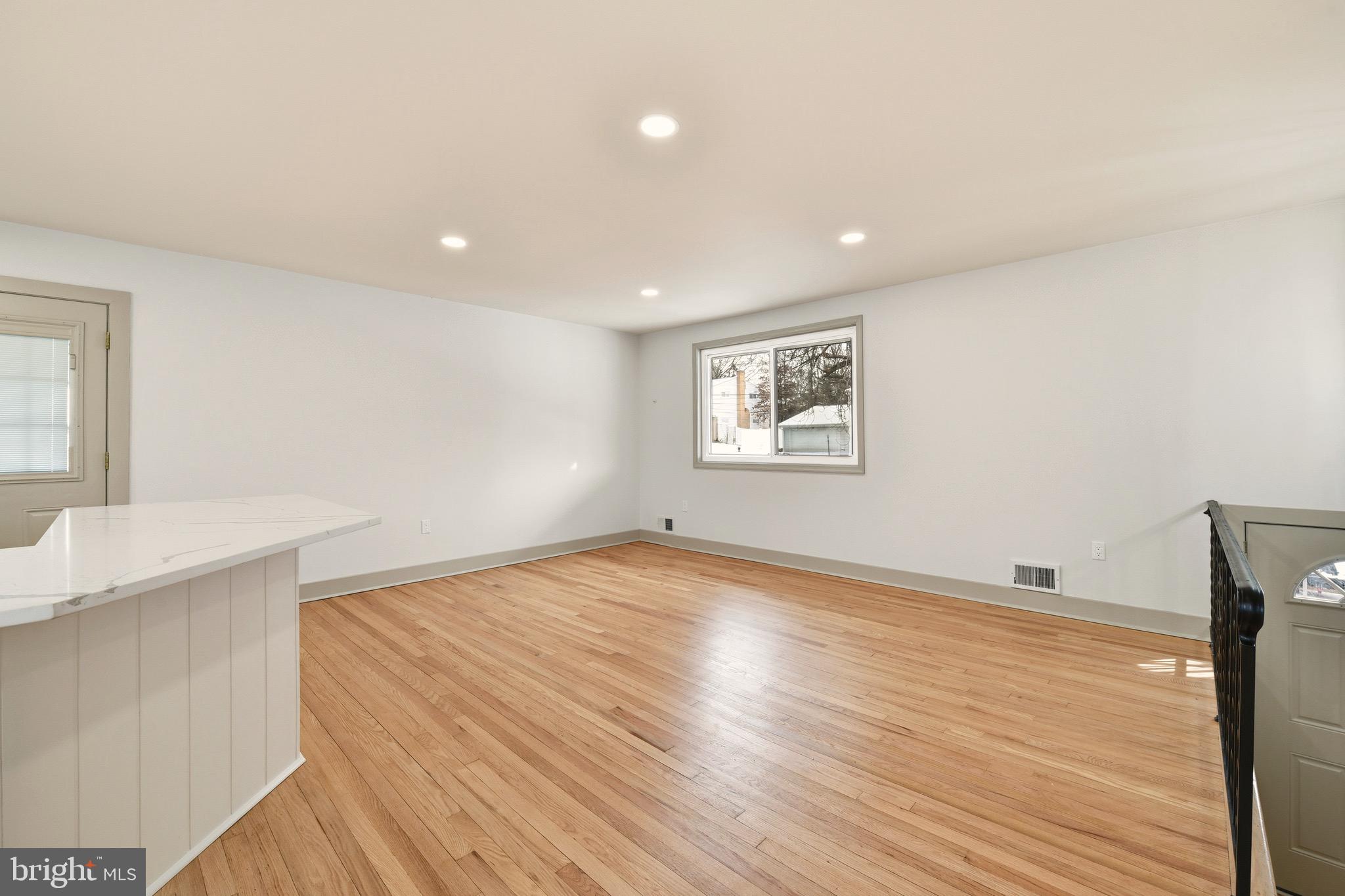 5717 Colon Terrace Temple Hills, MD 20748 - Photo 10 of 32 a view of an empty room with wooden floor and a window
