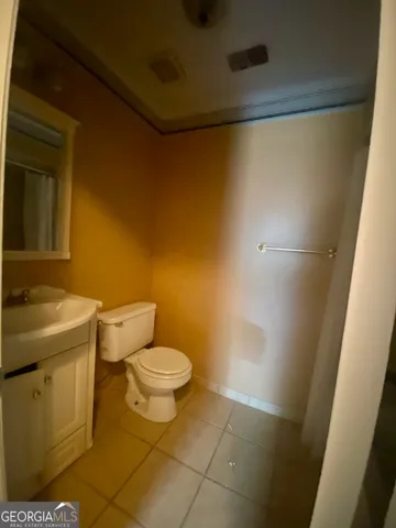 a white toilet sitting next to a bathroom sink