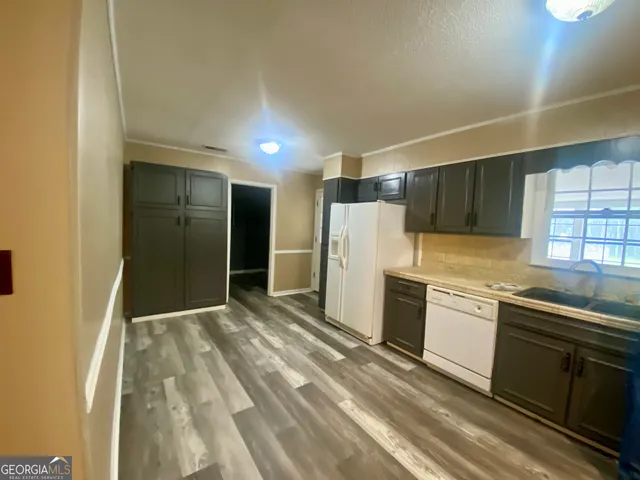a kitchen with stainless steel appliances granite countertop a refrigerator and a sink