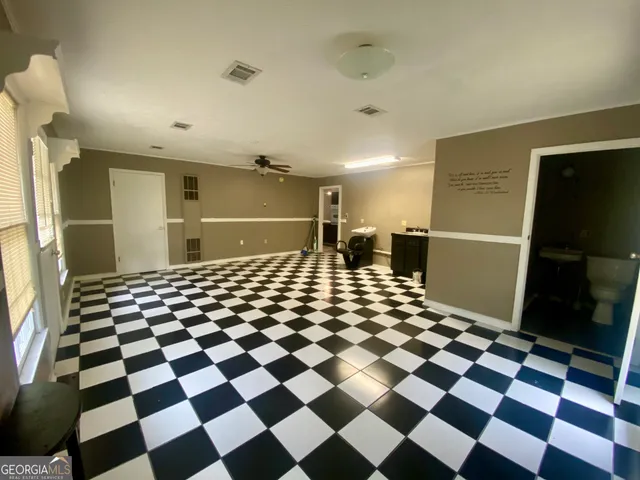 a bathroom with a black and white checkered floor