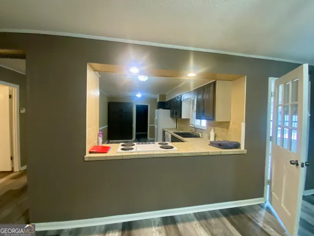 a view of kitchen with refrigerator and window