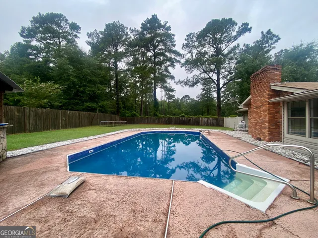 a view of swimming pool with a yard