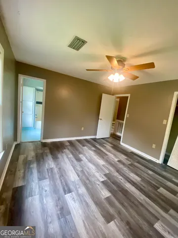 a view of a room with wooden floor and staircase
