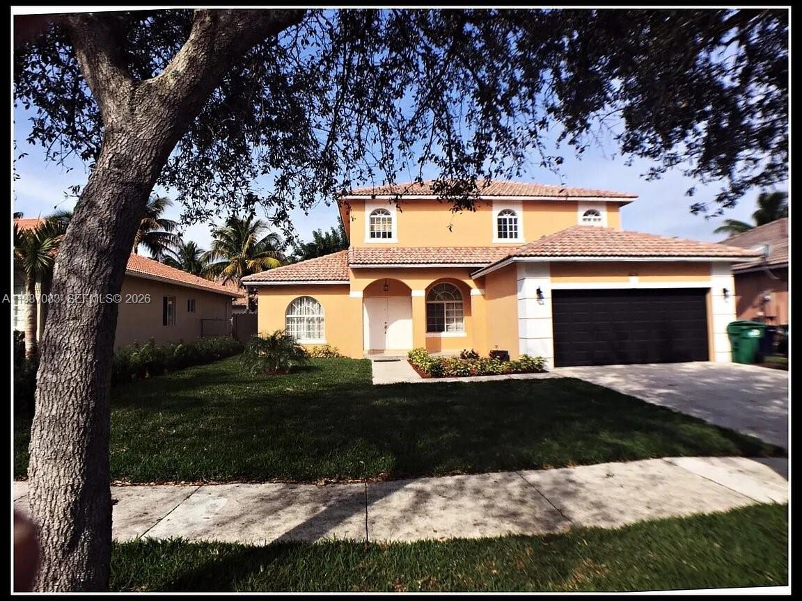 16131 Southwest 151st Terrace Miami, FL 33196 - Photo 1 of 55 a front view of a house with a yard