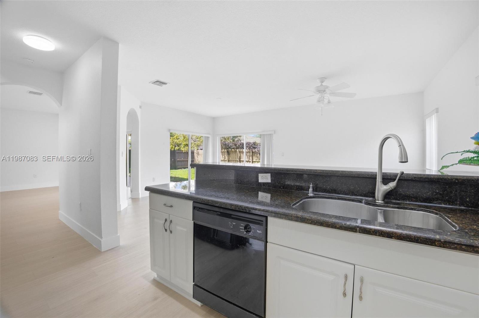 16131 Southwest 151st Terrace Miami, FL 33196 - Photo 19 of 55 a kitchen with granite countertop a sink and cabinets