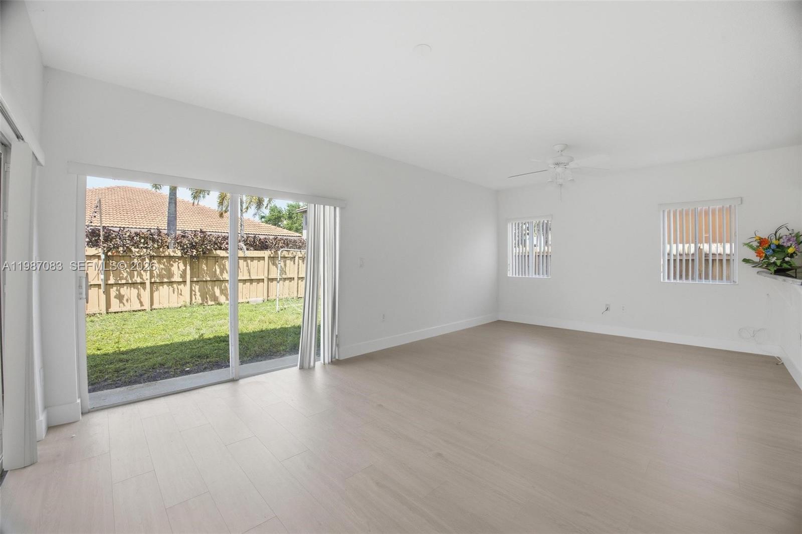 16131 Southwest 151st Terrace Miami, FL 33196 - Photo 20 of 55 wooden floor in an empty room with a window